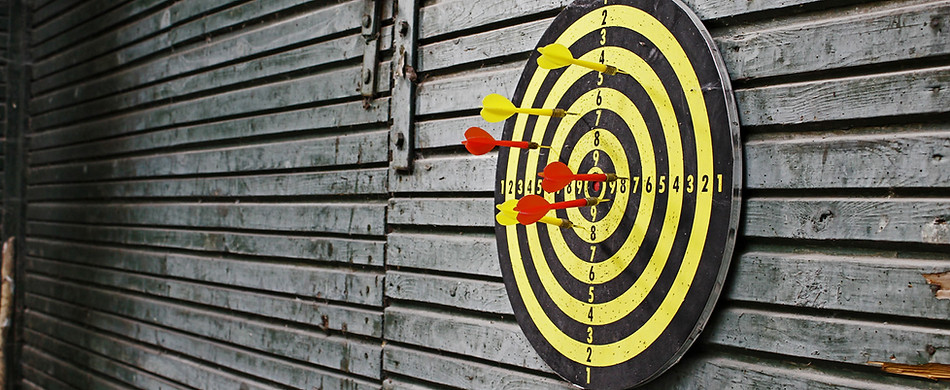 Darts in dartboard on wall