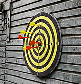 Darts in dartboard on wall