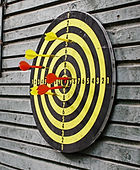 Darts in dartboard on wall