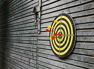 Darts in dartboard on wall