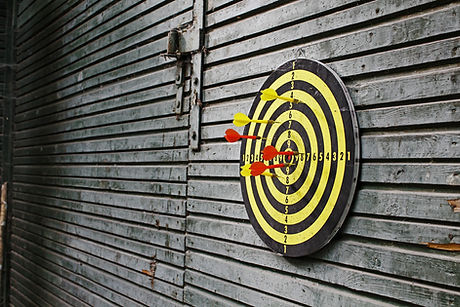 Darts in dartboard on wall