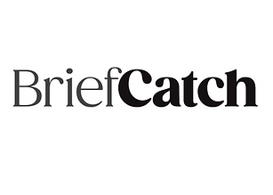 Image of a cup of coffee, newspaper and part of a laptop