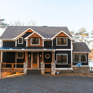 5- exterior view of a custom home in Blairsville, GA overlooking Lake Nottely. Multiple levels of a outdoor covered deck.