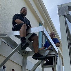 Our owner sitting on a cantilever while preparing it for generator installation.