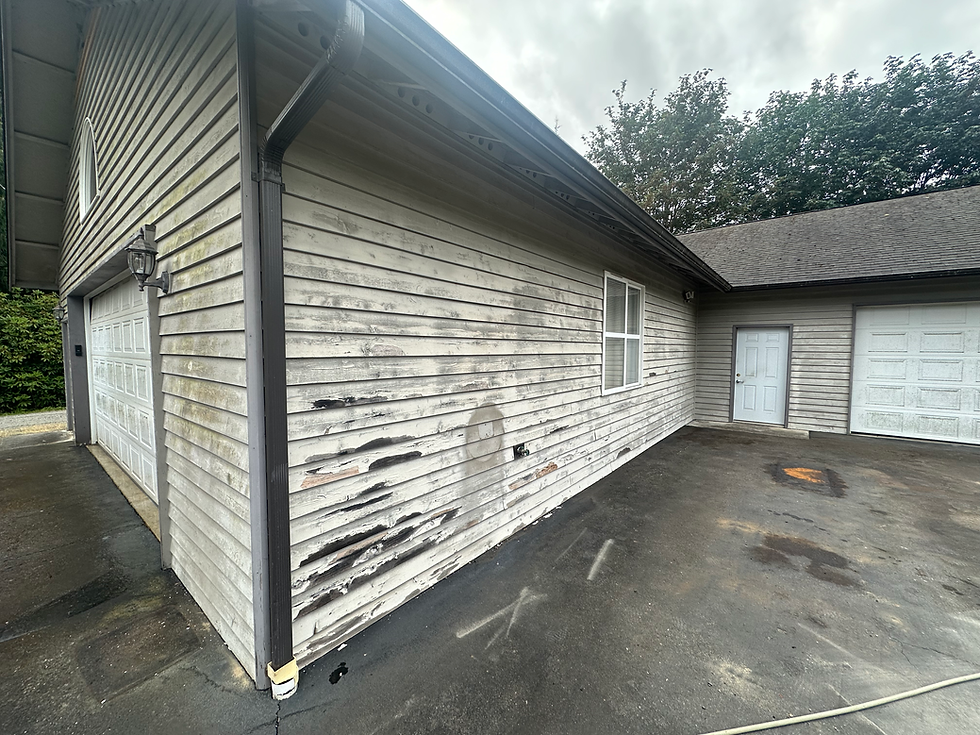 Weathered siding on detached garage with peeling paint. Very dilapidated 