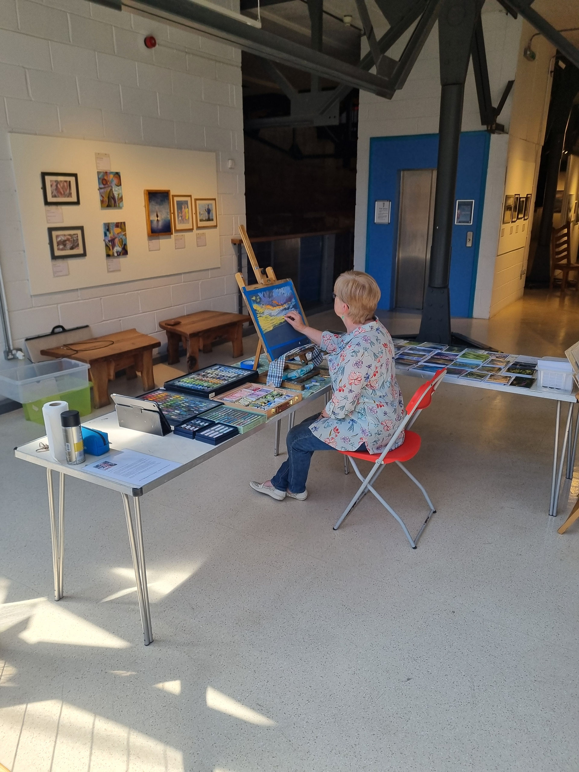 Artist painting at an easel for Barrow Society of Artists
