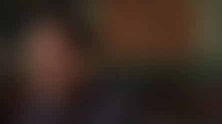 A man smiles to an interviewer off camera