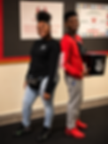 2 students holding black peace warrior bucket.png