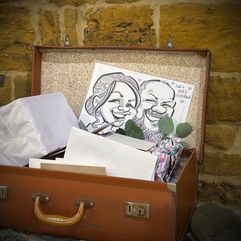 their caricature drawn on the spot by Vix Caricatures at a wedding