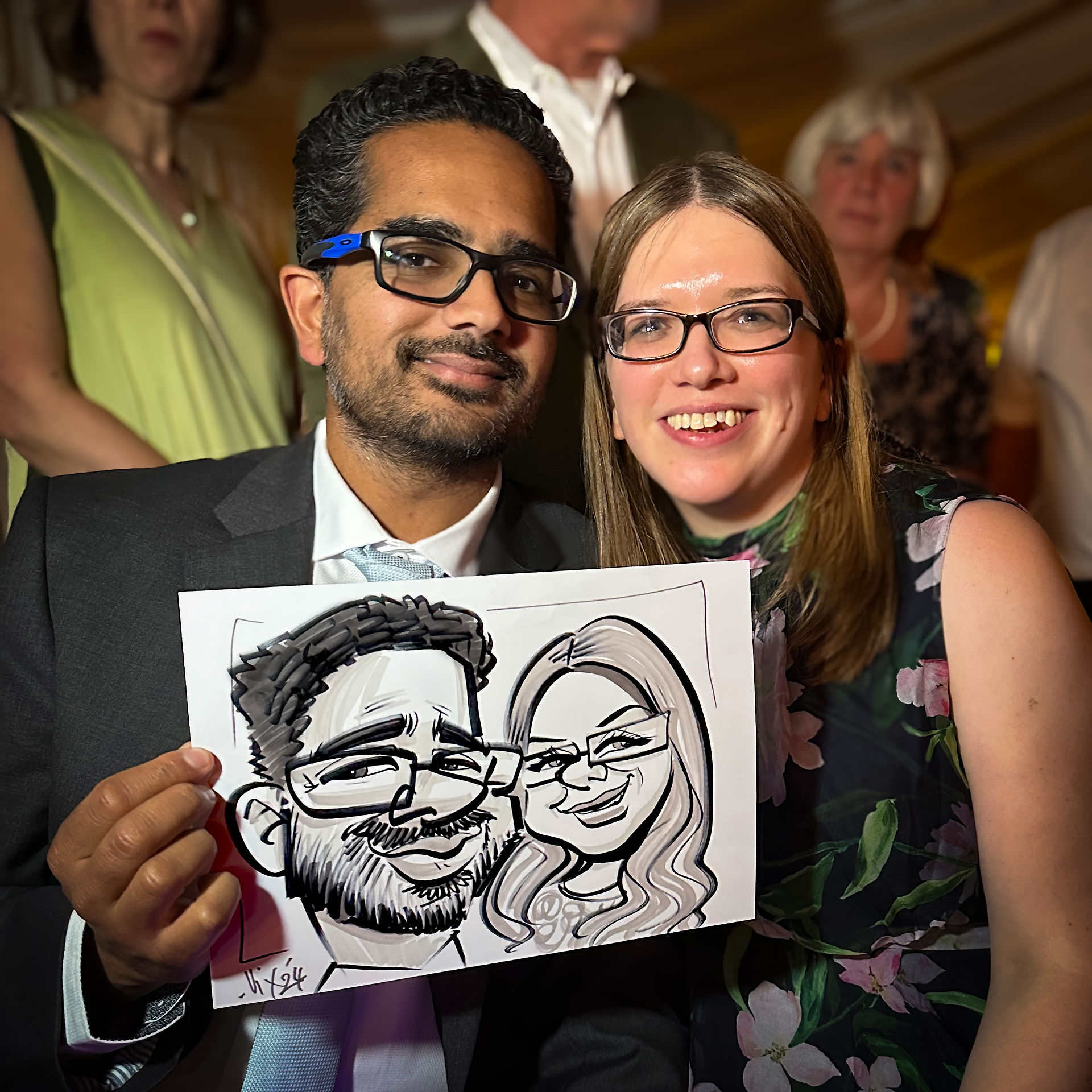 Professional Caricaturist entertains at a wedding in the Midlands drawing super fast sketches of the guests as well as the bride and groom by Vix Caricatures