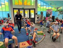 VR facilitators assisting students in immersive learning environment, showing hands-on support