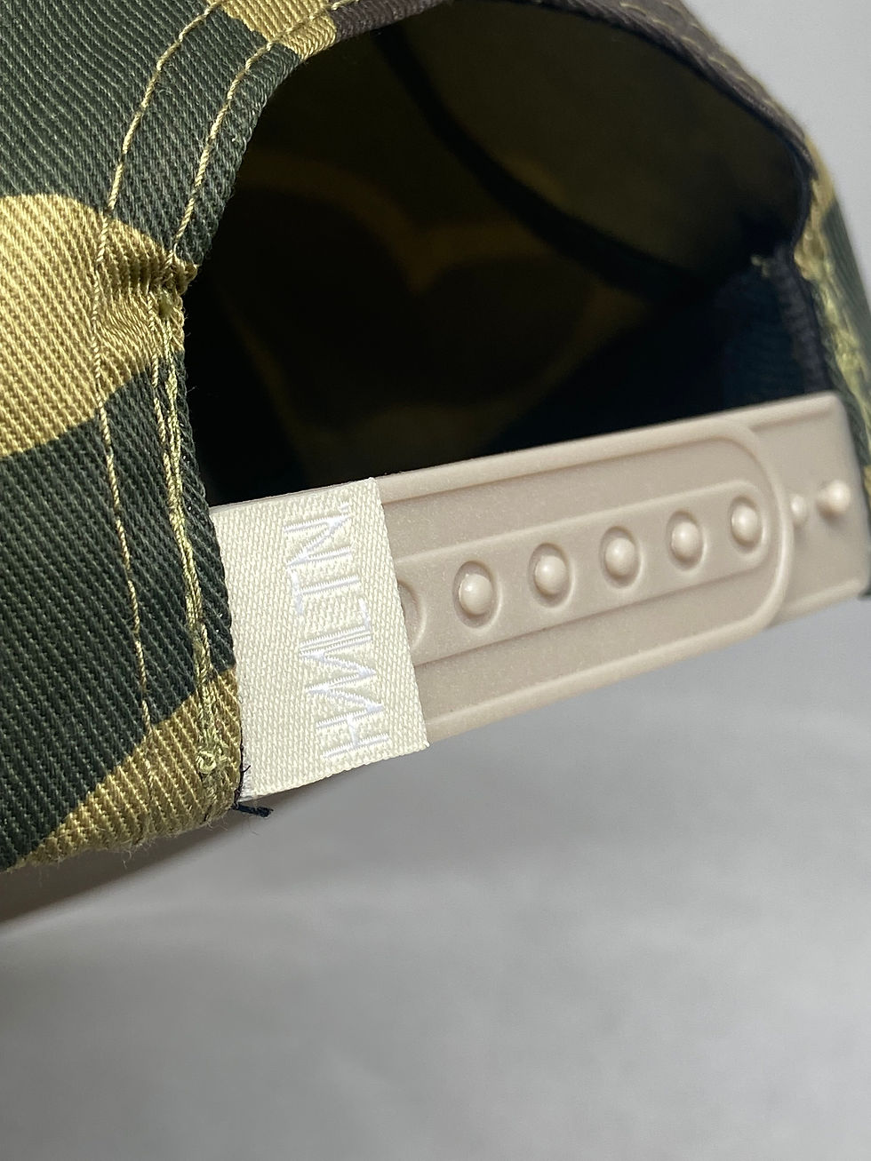 Thumbnail: close up of cream snapback closure hmltn clothing tampa