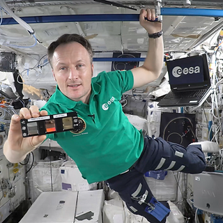 ESA Astronaut Matthias Maurer holding the Touching Arrays with the NIMFS during his space classroom. Credit: ESA/NASA