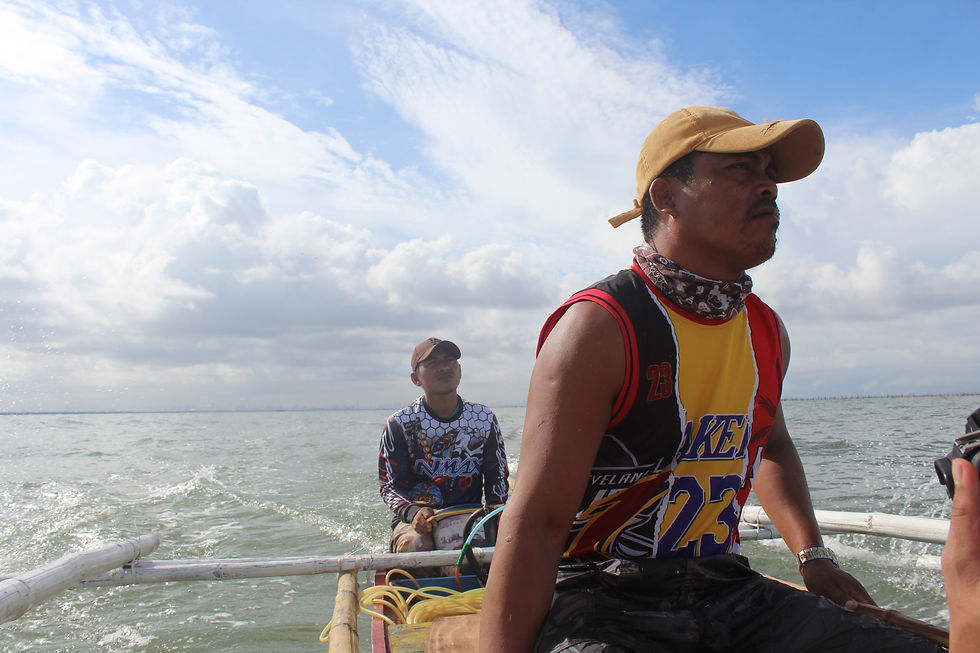 AFTER THE STORM. Daryl (left) and Michael Cabanza (right) steer a tiny, yellow boat to check for leftover mussels in their baklad after Typhoon Chedeng struck Luzon, June 11, 2023. Photo by Christonette Nuevo.