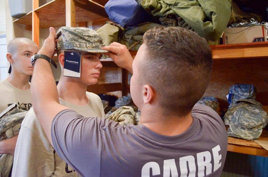Cadre issuing and fitting camouflage uniform equipment at the Central Issue Facility