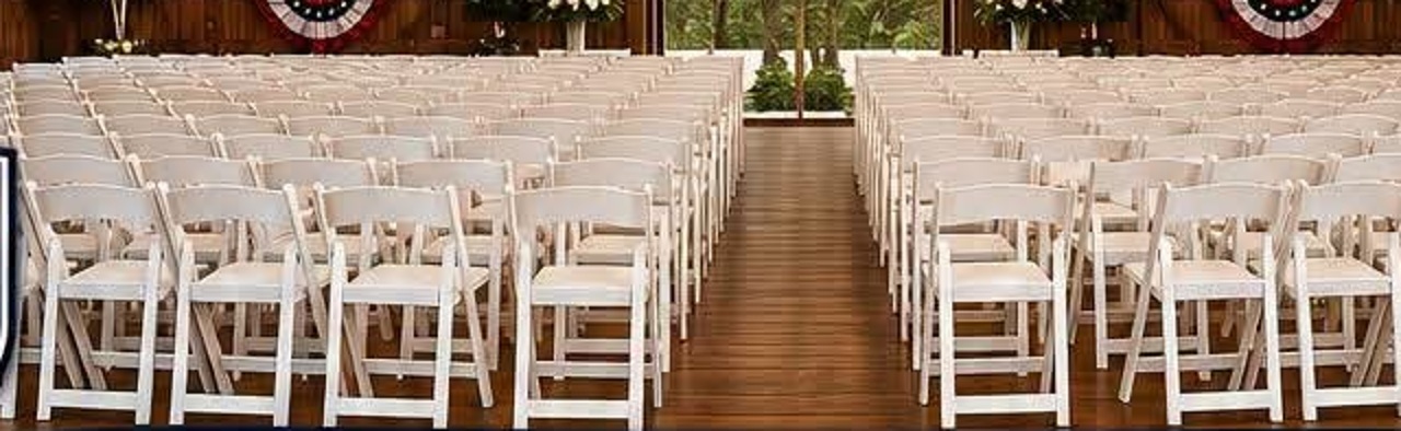 Rows of Camp Liberty white resin folding chairs set for an event