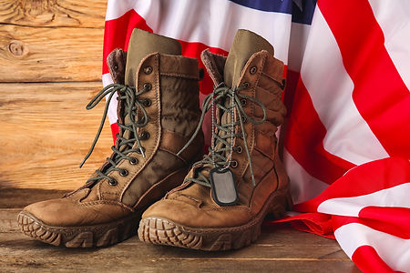 Military boots, tag and USA flag on wooden background.jpg