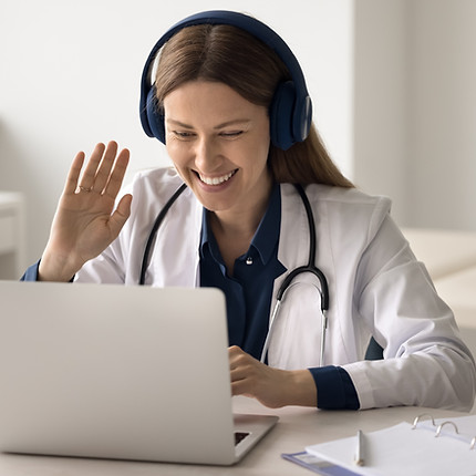 Telehealth innovations Smiling young woman doctor in headphones wave hand hello hi look on