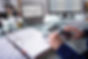 Close-up Of A Businessperson's Hand Calculating Invoice At Workplace.jpg