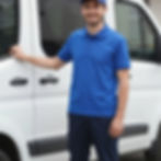 Smiling courier by a van for same day delivery service.