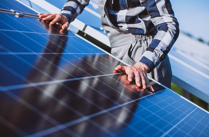 man-worker-firld-by-solar-panels.jpg