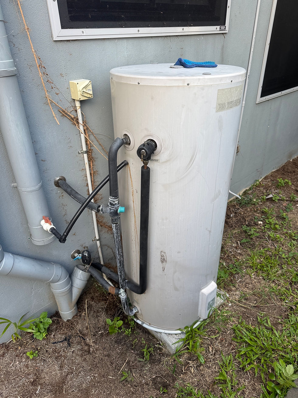 Aged hot water system with worn components and faulty tempering valve affecting performance