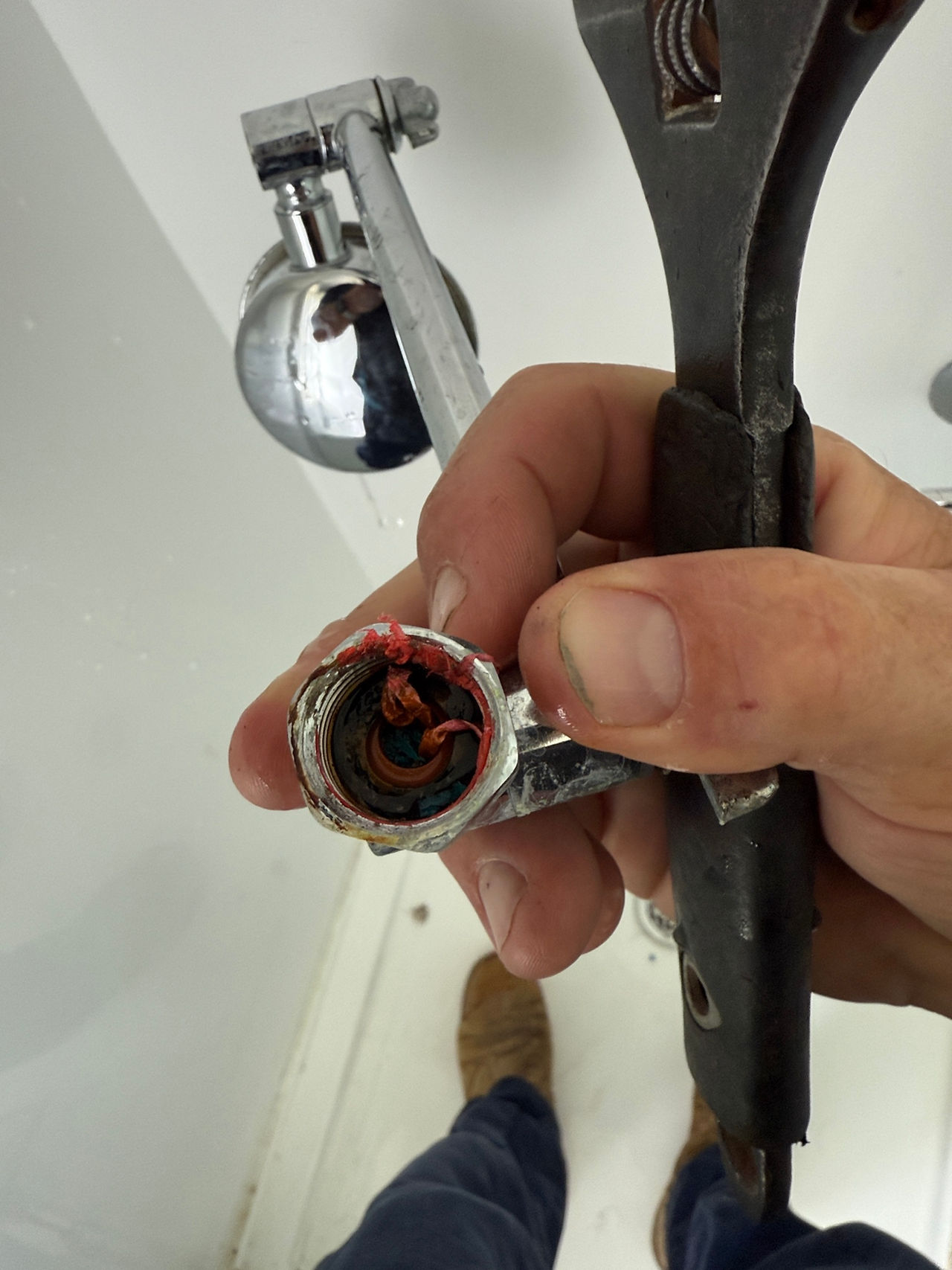 Blocked shower head caused by foreign matter buildup restricting water flow