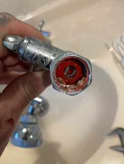 Shower head blockage caused by clogged flow disc and foreign debris restricting water output