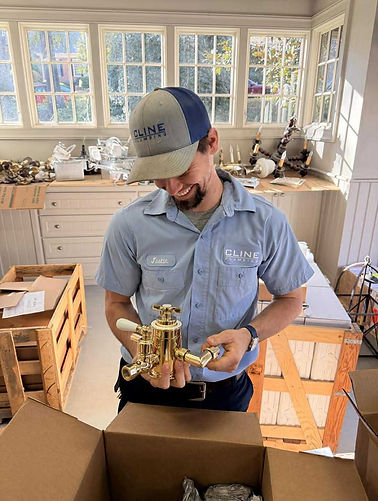 New gold faucet installed on bathroom vanity by local Greenville plumber.