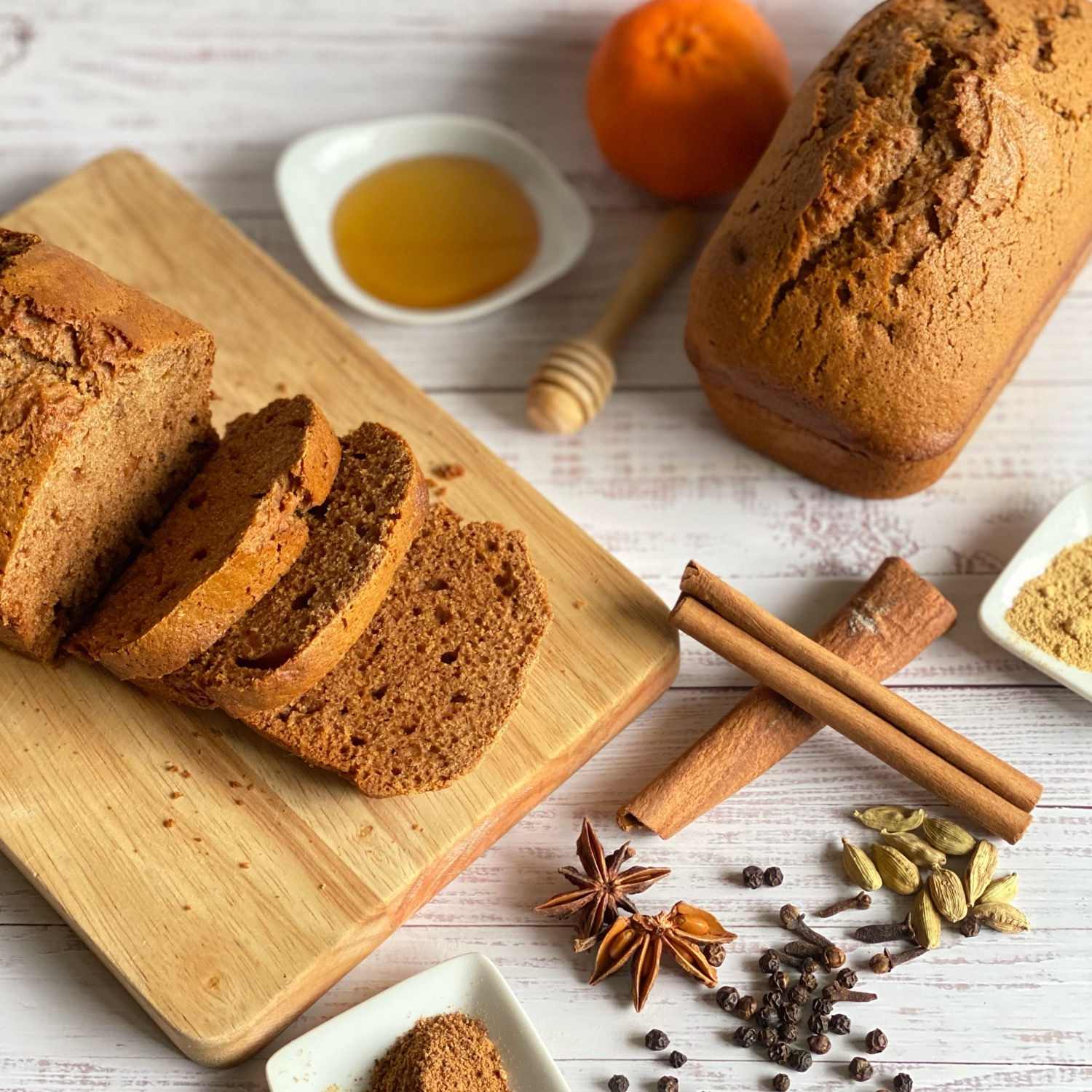Traditional French pain d’épices loaf sliced on wooden board showcasing spices