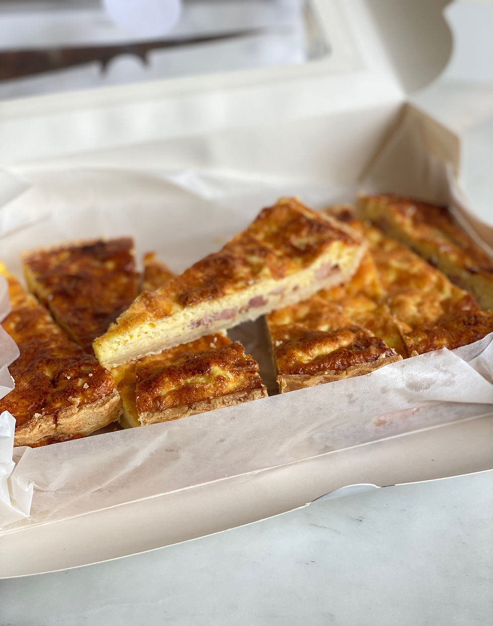 Onion confit quiche cut into portions