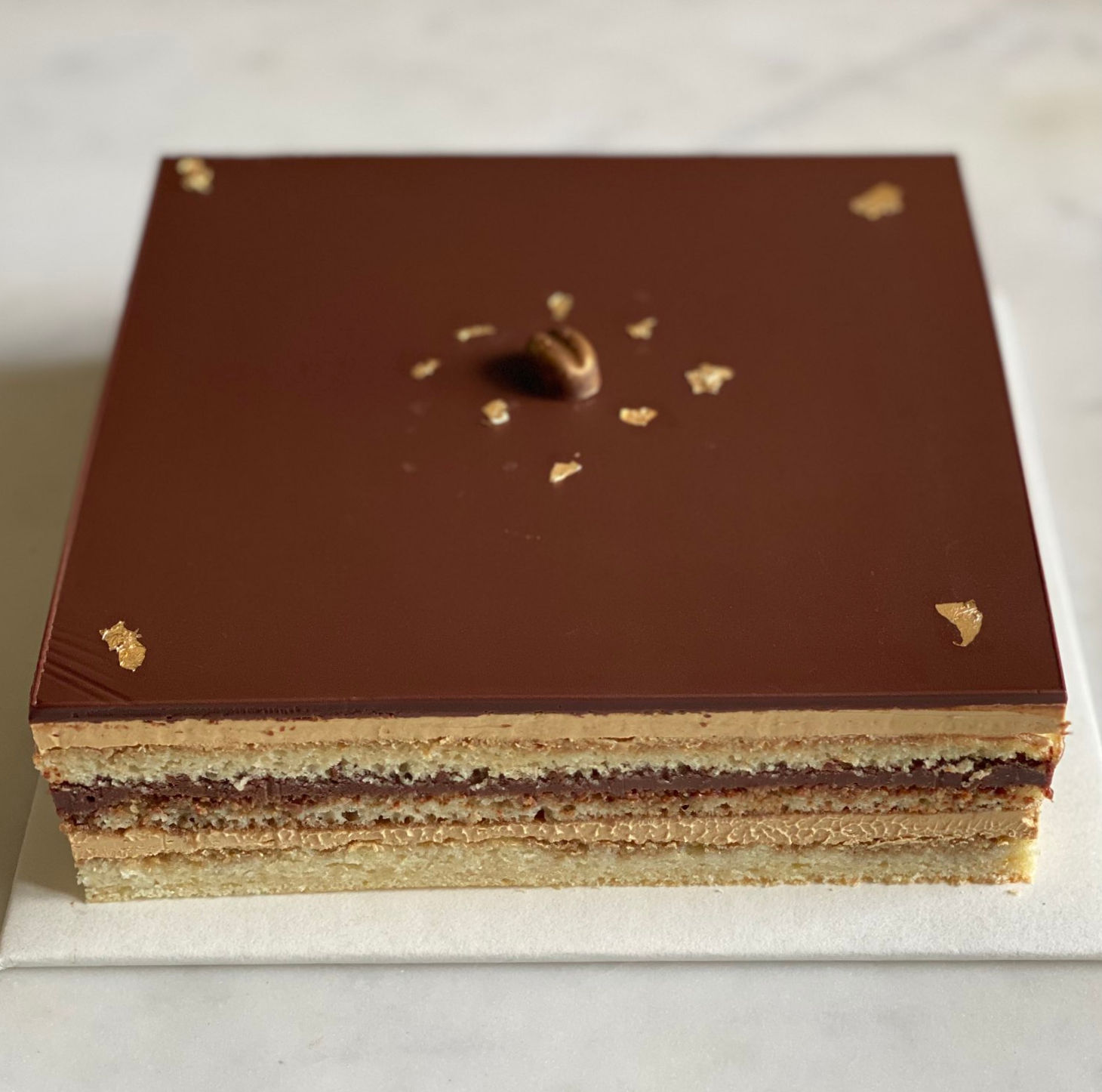 Classic French Opera cake with glossy chocolate glaze, layered cross-section