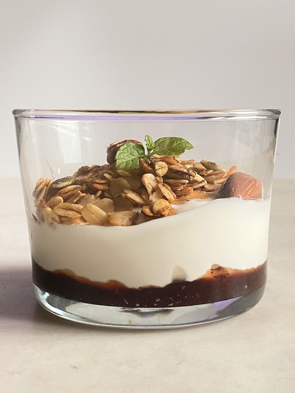 Greek yogurt cup with homemade red berries jam and artisanal granola topping – continental breakfast option handmade in HK