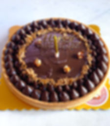 Hazelnut chocolate tart with glossy ganache, praline decoration – French artisanal tart handmade in Hong Kong