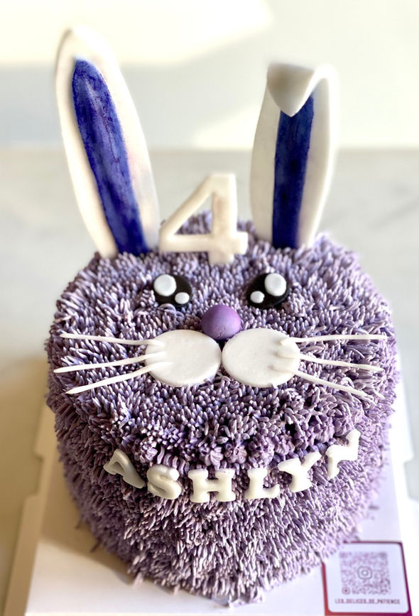 Purple bunny birthday cake with long fondant ears and buttercream fur, personalized for Ashly’s 4th birthday.