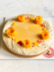 Mango and passion fruit tart with vanilla cream topping in a crisp tart shell