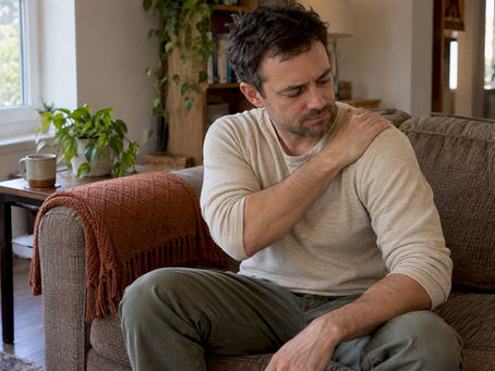 Patient checking shoulder soreness after adjustment