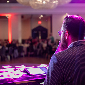 Man faces the crowd while he plays piano.