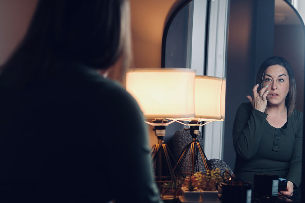 A girl looks at herself in the mirror.
