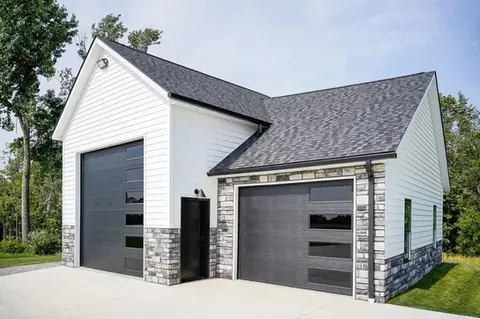 Modern home with gray and white garage doors