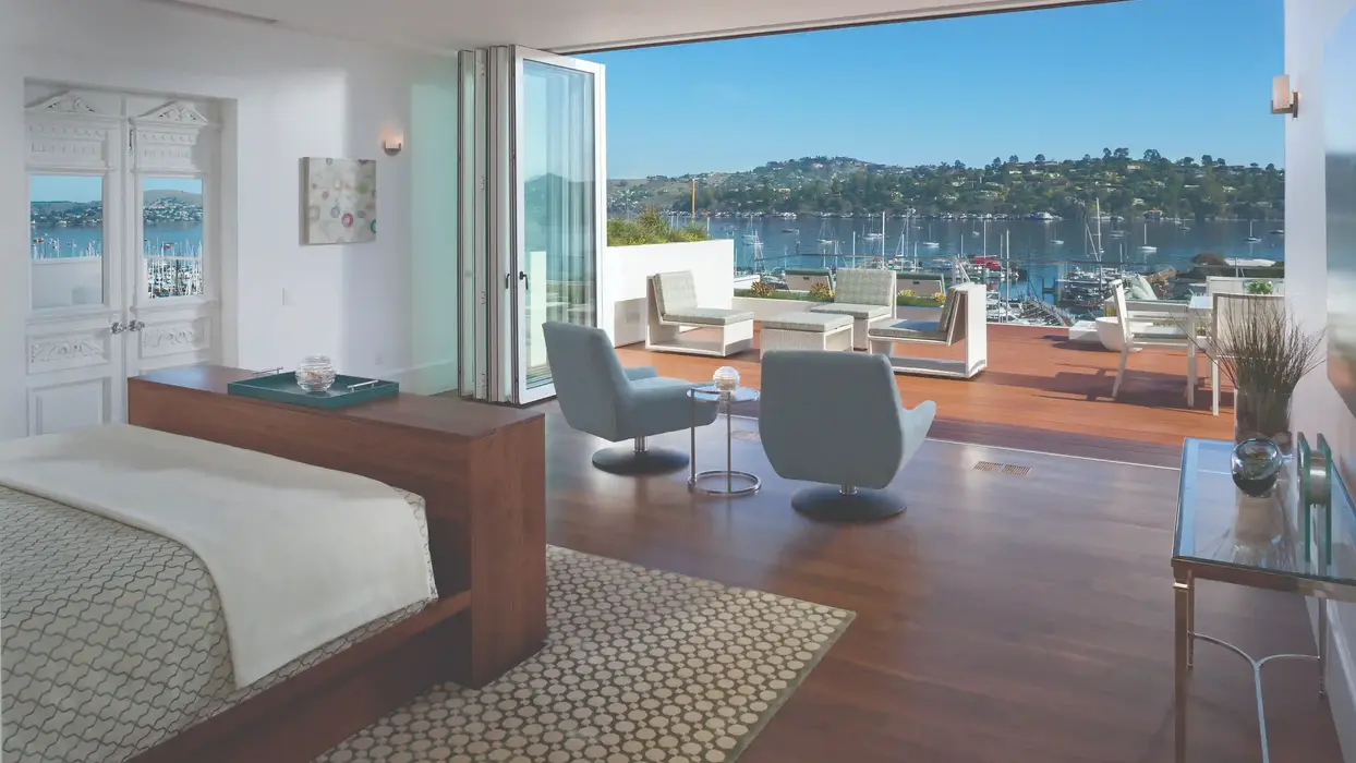 Modern bedroom with bay view: folding doors open to deck