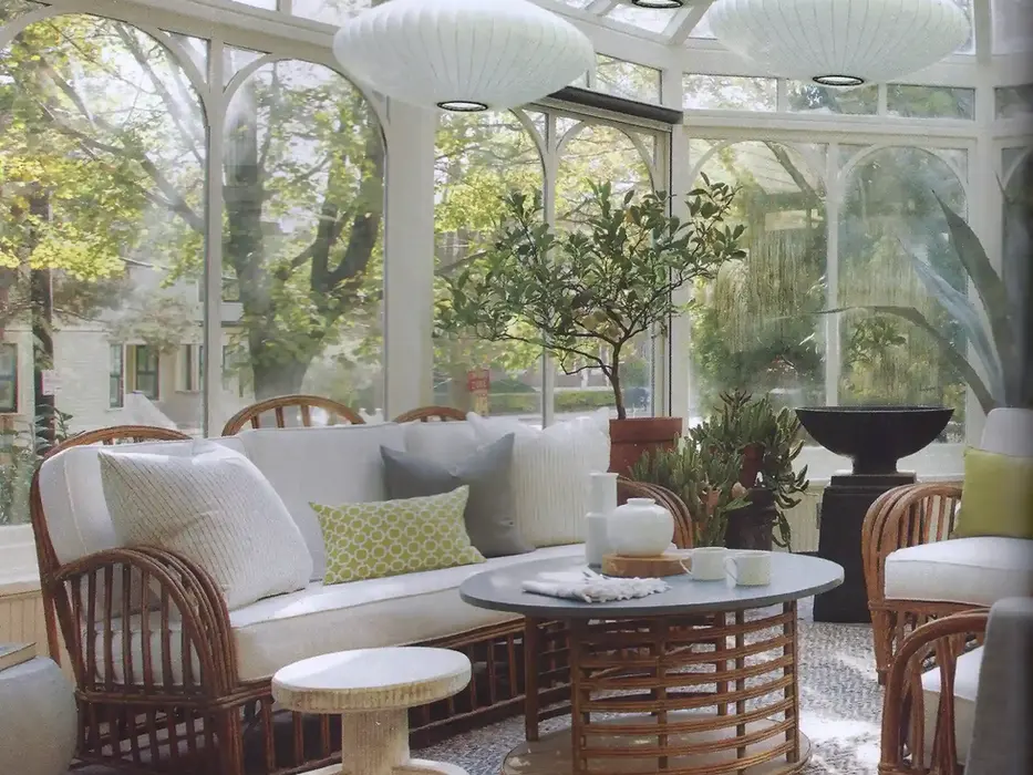 Sunroom wicker sofa, chairs, and table with three pendant lights