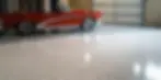 A freshly coated garage floor with a sleek, glossy finish, resistant to stains and cracks.