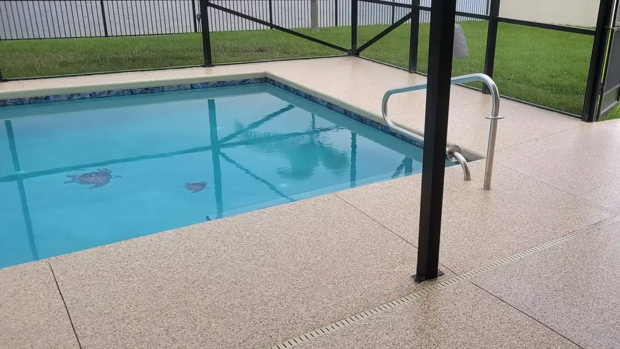 Inviting pool with turtle mosaic and new pool deck floor coating