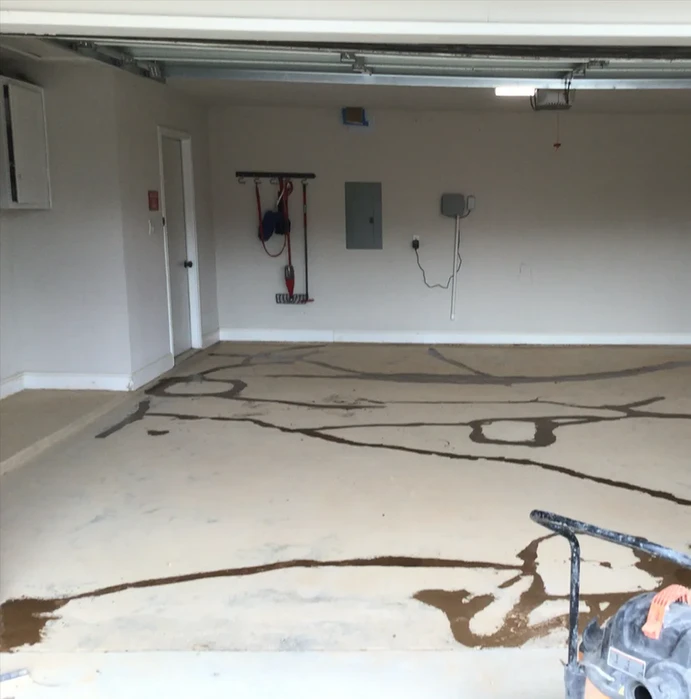Garage floor with cracked epoxy coating needing repair