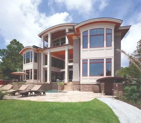 Luxury waterfront home with pool and large windows