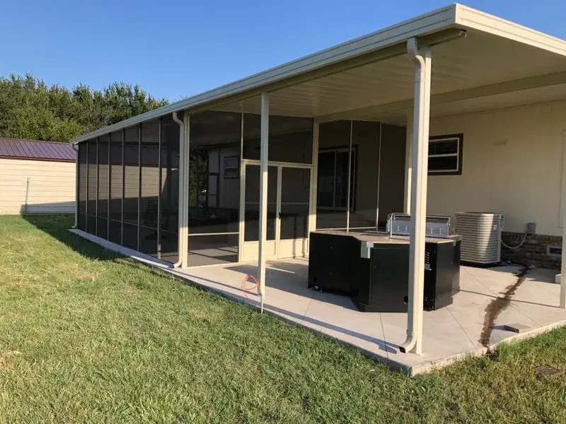 Tan aluminum patio enclosure with screen walls