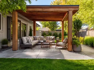Beautiful backyard with custom patio cover protecting outdoor furniture from sun and rain