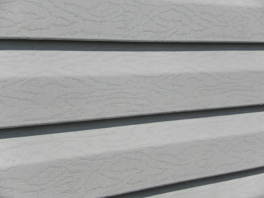 Close-up view of light gray wood siding