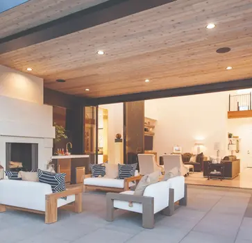 Outdoor patio furniture near fireplace and sliding glass doors